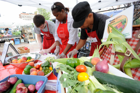 volunteers serve produce