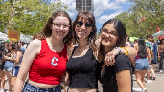 Three women pose for a photo on Ho Plaza. 